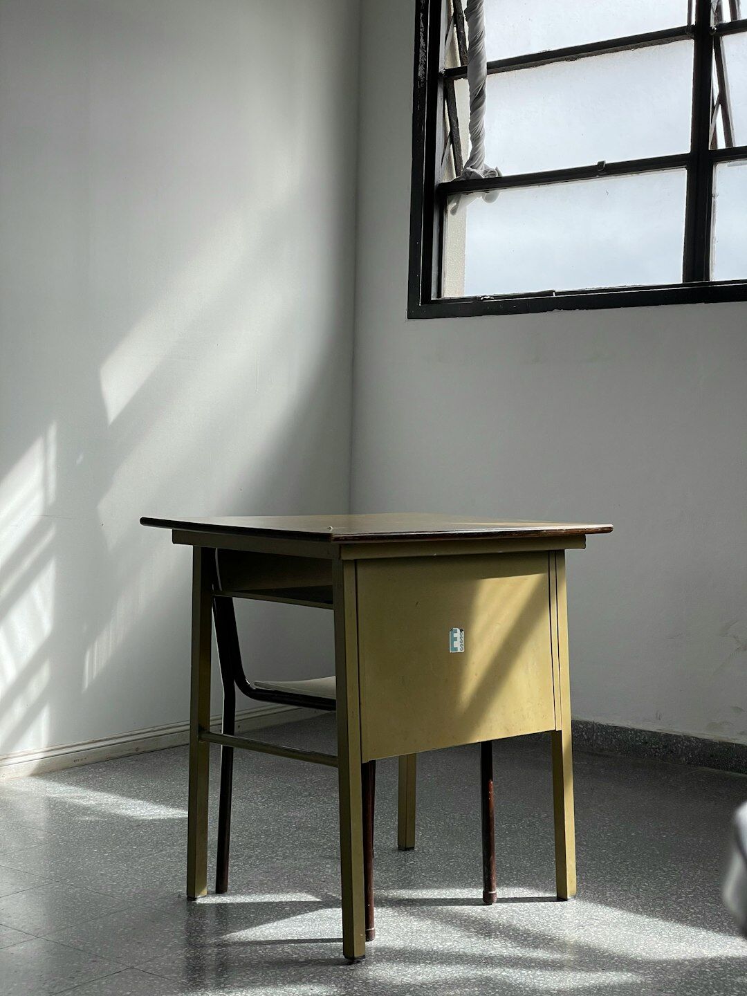 Editorial desk with typewriter, archival photographs and a desk lamp