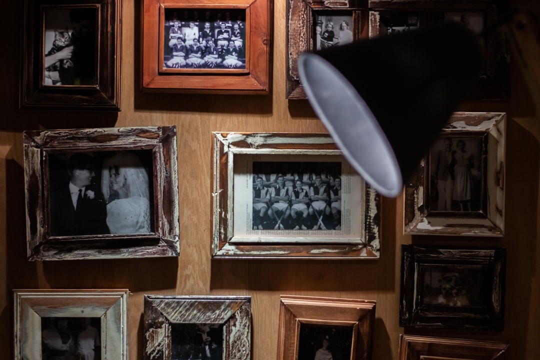 Gallery wall of vintage portrait frames under warm lighting