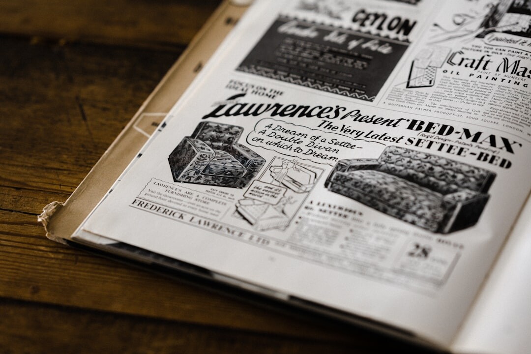 Vintage 1990s magazine layout table with printed proofs and a loupe
